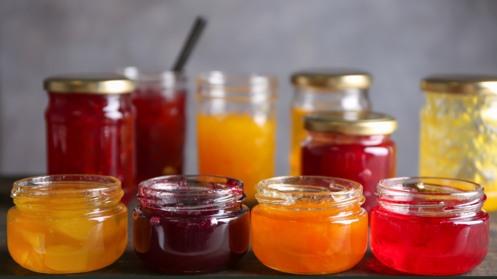 Jars of fruit preserves in a variety of colors representing different ingredients, showcasing the range of sourcing options