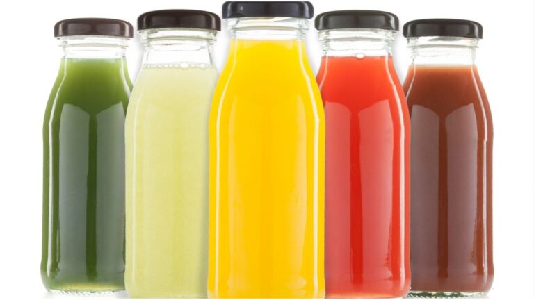 A variety of colorful juices in bottles, representing different flavors and natural food colors.